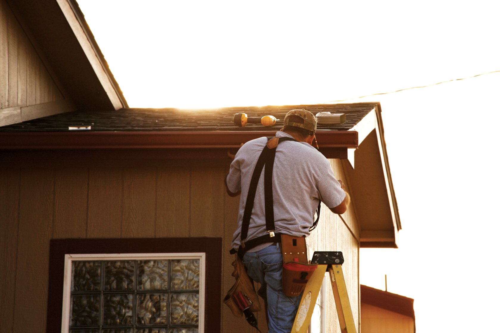 Man Installing Seamless Gutters